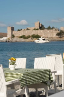 Bodrum, Mugla, Turkey. April 21st 2022 Pretty seaside cafe restaurant tables with table cloths and