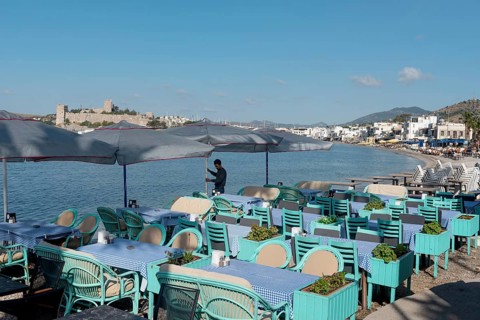 Bodrum, Mugla, Turkey. April 21st 2022 A waiter prepares tables on the beach side cafe in Bodrum