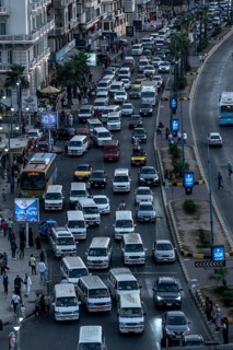 Busy traffic with lots of public mini buses along the Mediterranean Sea front of Alexandria, Second