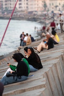 Alexandria, Egypt. December 1st 2022 Young Egyptian women sit on concrete sea defence walls in the