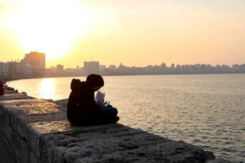 Alexandria, Egypt. December 1st 2022 A Muslim Egyptian female student studying on the corniche