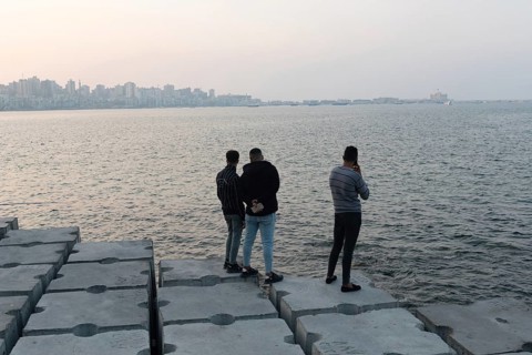 Alexandria, Egypt. December 1st 2022 Young Egyptian men standing on large concrete blocks designed