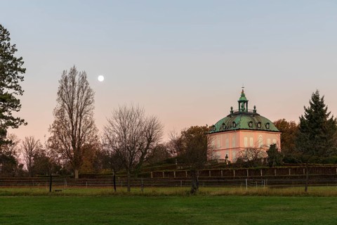 Full moon over the pheasant castle in Moritzburg at sunrise, Saxony, Germany