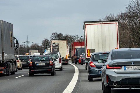 Driving on the A57 motorway, at the Kamp-Lintfort interchange, 3 lanes, traffic jam due to