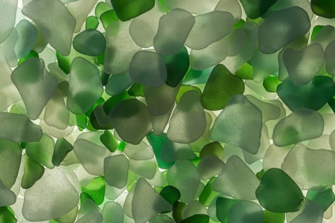 White and green broken glass cut by the sea, sea glass, sea glass, beach glass from the North Sea