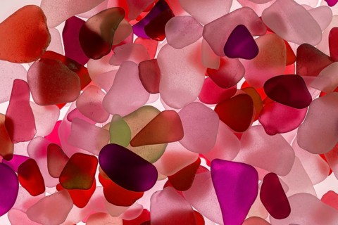 Red broken glass cut by the sea, sea glass, sea glass, beach glass from the North Sea