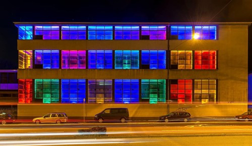 Colourfully illuminated window front in a Frankfurter Mainova AG building, city center, Frankfurt