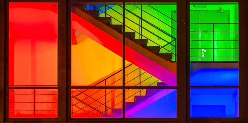 View through the windows of a brightly lit staircase. Frankfurter Mainova AG building, city center,