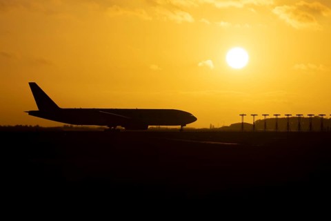 Boeing 777 A7-BFL commercial jet aircraft of Qatar cargo waiting to take off silhouette at sunset