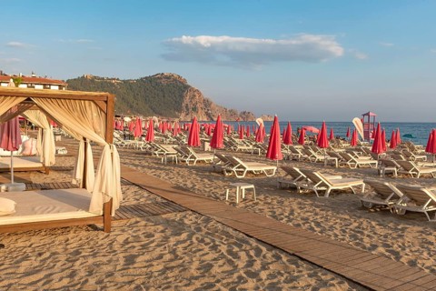 Alanya, Turkey. July 9th 2024 Sunbeds and pink sunshades on Cleopatra Beach in the Turkish holiday
