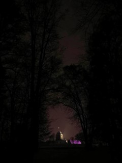 Building hidden in the dark, dimly lit Rosenberg Fortress surrounded by trees, Kronach, Frankenwald