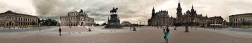 Panorama, spacious square with equestrian statue in Dresden with woman in green dress surrounded by