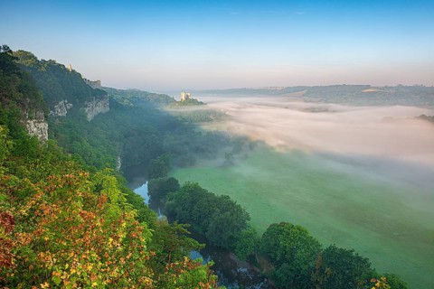 View of the ruins of Saaleck and Rudelsburg castles and the river Saale in autumn morning fog in
