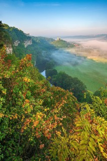 View of the ruins of Saaleck and Rudelsburg castles and the river Saale in autumn morning fog in