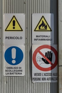Warning signs on a factory gate, Veneto, Italy
