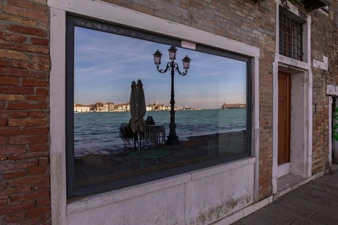 Venice is reflected in a shop window on the island of Guidecca, Venice, Veneto, Italy