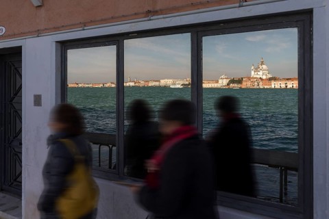 Santa Maria della Salute is reflected in a shop window on the island of Giudecca, Venice, Veneto,