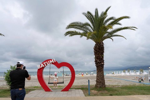 Batumi, Georgia. July 21st 2025. A father takes a photo of his daughter with the heart shaped