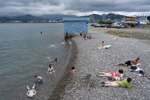 Batumi, Georgia. July 21st 2025. Georgian locals relax on the beach near Batumi Port on the Black