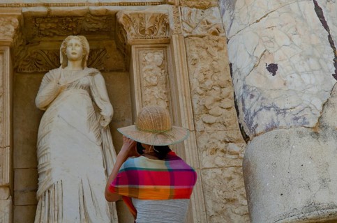 Ephesus, Turkey. July 2nd 2015 A foreign tourist takes a photogaph of a Greek statue at Ephesus,
