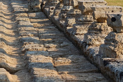 Set of ancient stones with long shadows showing detail, Archaeological Site, Ancient Olympia,