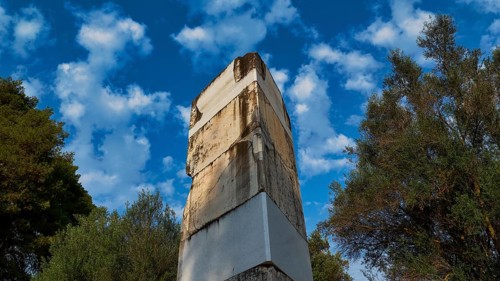 Ancient wall against cloudy sky and surrounded by trees, Archaeological Site, Ancient Olympia,