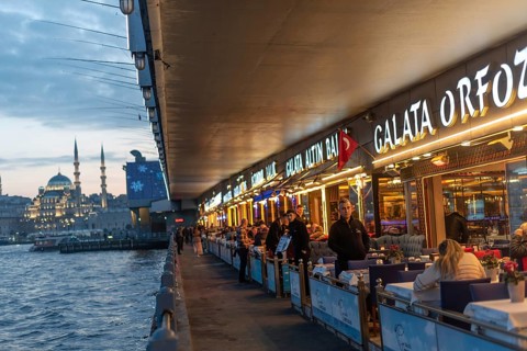 Istanbul, Turkey. January 3rd 2025 Fish restaurants at night on the the iconic Galata Bridge at the