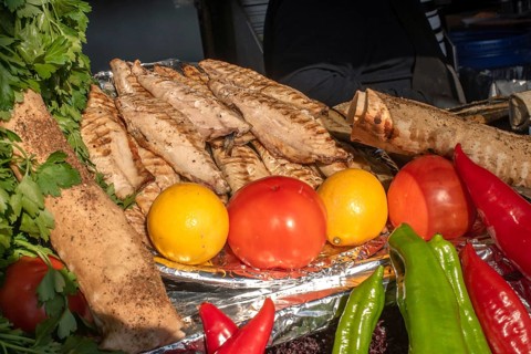 Tasty looking grilled mackerel and fresh vegetables ready to prepare Balik Ekmek, a traditional