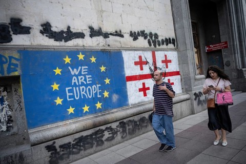 Tbilisi, Georgia. August 26th 2025. Georgian people walk past the flags of Georgia and the European