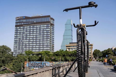 Tbilisi, Georgia. August 5th 2025. Iconic landmark of Big Bike Monument and the Radisson Blu Hotel