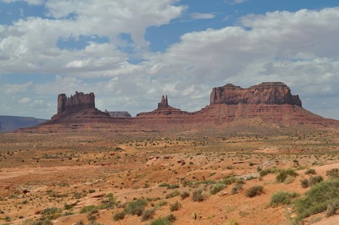 Impressive rock formations rise in a sunny desert landscape, Monument Valley, Navajo Tribal Park,