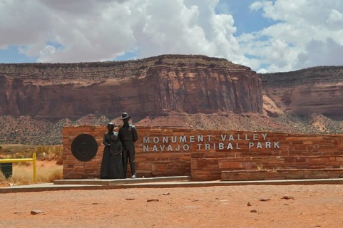 Sign at the entrance to Monument Valley, which is surrounded by impressive rock formations,