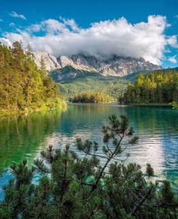 View over Lake Eibsee lake, the Wetterstein Mountains with the Zugspitze in the background, clouds