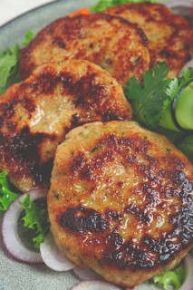 Fried chicken cutlets, minced chicken, with vegetables, on gray, with vegetable salad, top view,