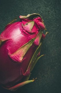 Dragon fruit, pitahaya, one piece, top view, rustic style, green background