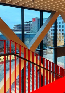 Staircase with signal red color scheme in seminar building H of Bochum University in the evening