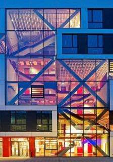 Bochum University seminar building in the evening with an eye-catching staircase with a signal red
