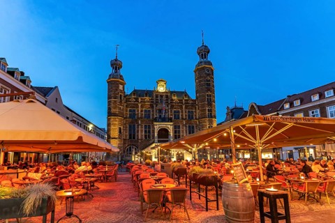 Restaurant and the historic town hall on the market in Venlo at dusk, the Netherlands