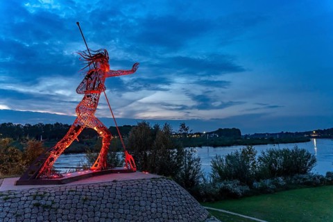 Peaceful Warrior Vreedzame Krijger sculpture on the Maas at dusk, Venlo, the Netherlands