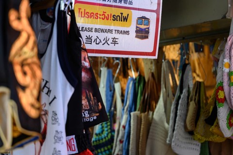 Mae Klong, Thailand. March 15th 2025. A sign warning tourists to beware of the train at the Mae