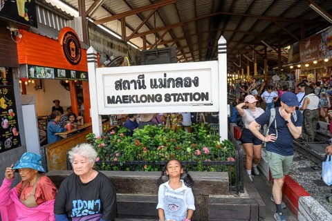 Mae Klong, Thailand. March 15th 2025. Tourists at the entrance to The Maeklong Railway station in