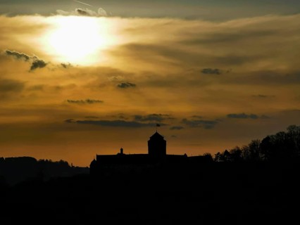 Silhouette of Rosenberg Fortress in Kronach in front of dramatic sunset sky, Frankenwald nature