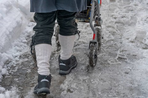 Detail, elderly man pushes his walker through slush in the city, Nuremberg, Middle Franconia,