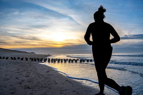 Winter on the North Sea, sunset at the beach, joggers, beach walkers, coastal protection, through