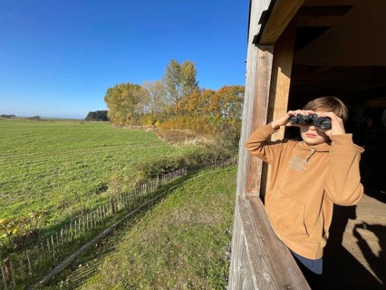 Boy watching cranes with binoculars, Perfect place to watch cranes, Nabu, Crane panorama at Günzer