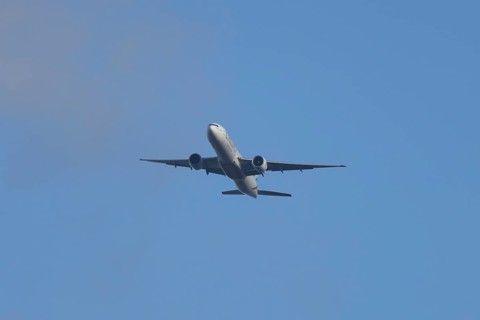 Boeing 777 commercial passenger airliner jet aircraft of Emirates airways in flight at London