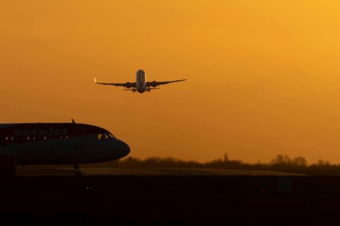 Airbus commercial passenger airliner jet aircraft taking off in flight with another plane on the