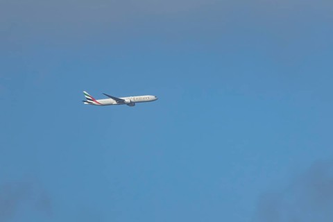 Boeing 777 commercial passenger airliner jet aircraft of Emirates airways in flight at London