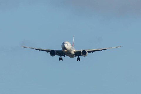 Boeing 777 commercial passenger airliner jet aircraft of Emirates airways in flight on approach to