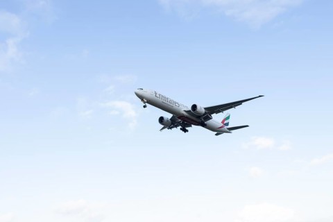 Boeing 777 commercial passenger airliner jet aircraft of Emirates airways in flight on approach to